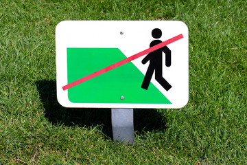 sign of forbidden walk on grass