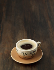Warm cup of coffee on wooden background