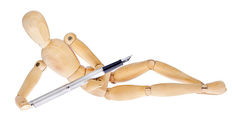 Wooden figures lying with fountain pen