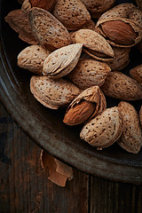 Almonds with shell on a ceramic plate