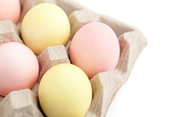 Colorful eggs are in the cardboard box for egg delivering