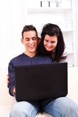 Obraz na płótnie Canvas Happy couple with laptop