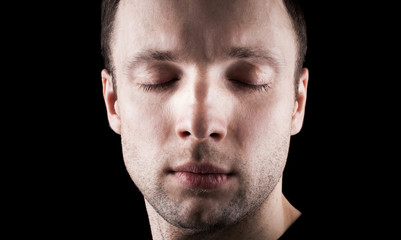 Fototapeta premium Young Caucasian man's portrait with closed eyes