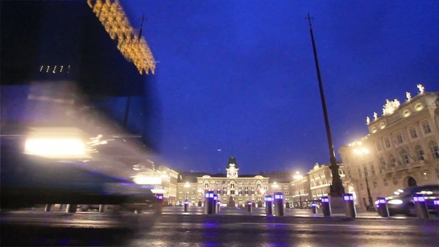 urban traffic during a weak snow in trieste central square