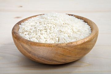 Fototapeta na wymiar a bowl of rice on wooden surface