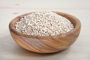 a bowl of pearl barley on wooden surface