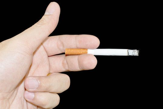 hand holding a cigarette on a black background