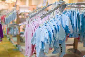 Body clothes for newborn babies on stands in kids store