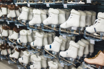 Variety of ice skates on stands and walls in sport store
