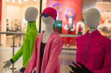 Kids mannequins equipped with sport clothes in store