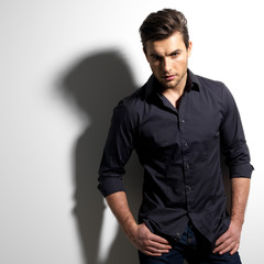 Fashion portrait of young man in black shirt