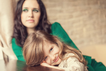 Mom and young daughter eating breakfast