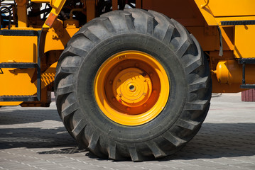 big wheel on yellow tractor
