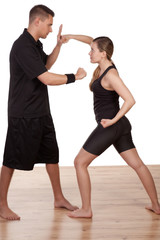 Obraz premium Woman and man practising kick boxing