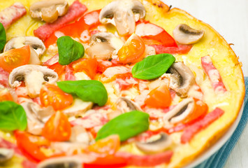 pizza with mushrooms, ham and vegetables