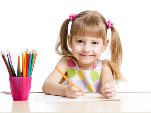 cute girl drawing with colourful pencils