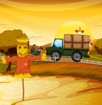 A scarecrew at the farm with a black bird