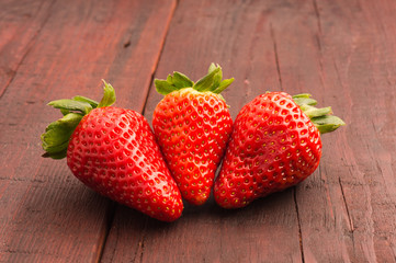 fresh strawberries scattered on the old planks