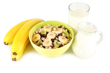 Delicious and healthy cereal in bowl with milk and fruit