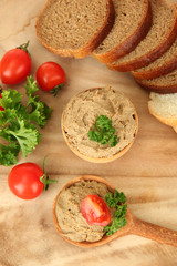 Fresh pate on wooden spoon, on wooden background
