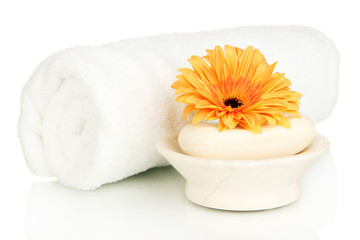 Obraz na płótnie Canvas Rolled white towel, soap bar and beautiful flower isolated