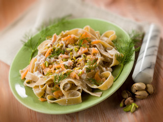 pasta with salmon pistachio and cream sauce, selective focus