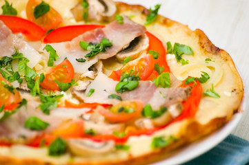 pizza with mushrooms, bacon and vegetables