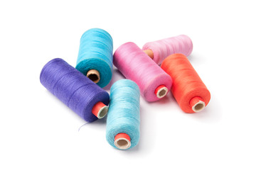 Colorful thread bobbins, isolated on white background