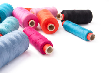 Colorful thread bobbins, isolated on white background
