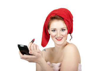 Ginger pin up girl, after shower, putting on make-up.