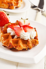 belgian waffles with fresh strawberries and whipped cream