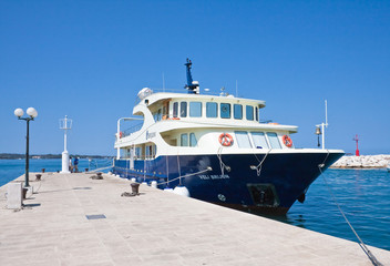 Tourist ship at the pier. Fazana, Croatia