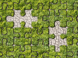 Puzzles from grass on cracked earth background
