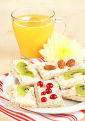 Tasty canapes with cheese, kiwi and cranberry, almond,
