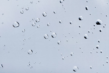 Water drops on glass closeup. May be used as background.