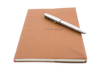 Brown notebook with pen isolated on white