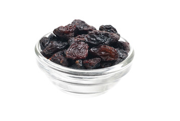 Dark  raisins close- up in glass bowl isolated  on  white