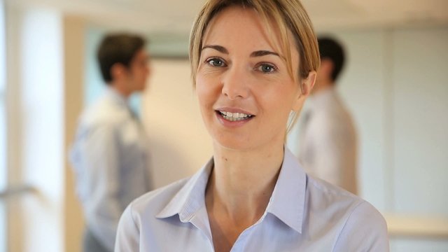 Businesswoman talking to camera