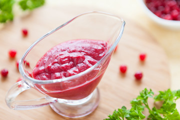 thick flavorful cranberry sauce in a glass gravy boat