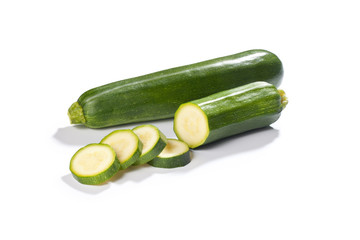 Fresh whole and chopped green zucchini isolated 