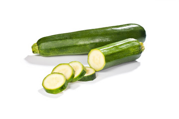 Fresh whole and chopped green zucchini isolated 