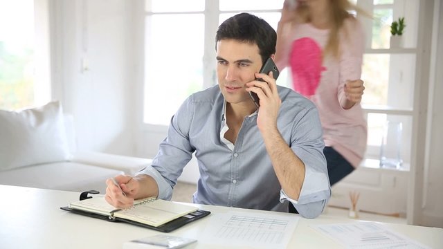 Man and woman calling each other with smartphone