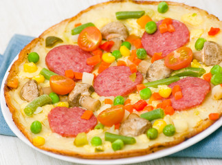 pizza with salami, mushrooms and vegetables