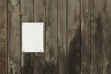wooden background with a blank sheet of paper