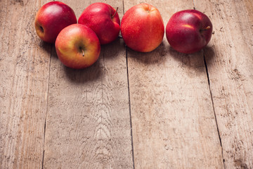 red apples on wooden background