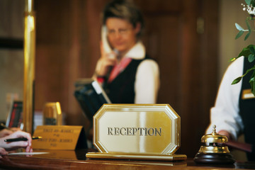 luxurious reception area with receptionist phoning