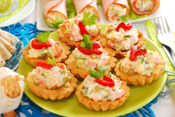 salty mini tartlets stuffed with vegetable and ham salad