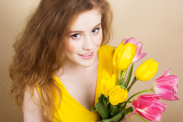 Beautiful redheared girl with tulips