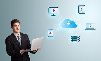young man holding a laptop and presenting cloud computing networ