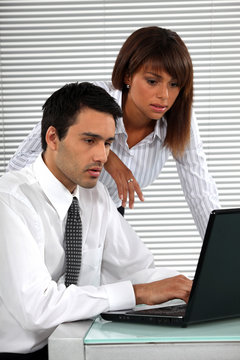 co-workers in front of laptop